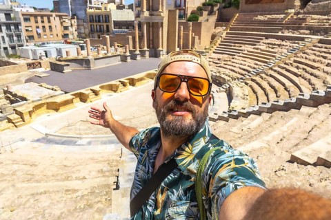 Happy traveler taking a selfie at the ancient roman theatre in cartagena, murcia, spain, exploring