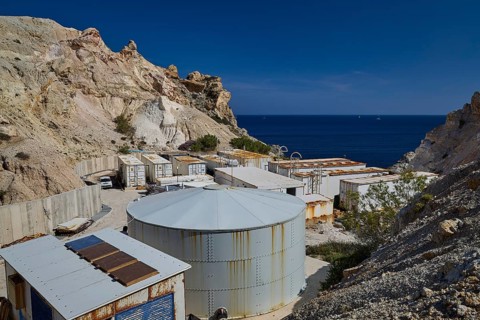 Seawater desalination plant, desalination plant on the coast surrounded by rocky landscape under
