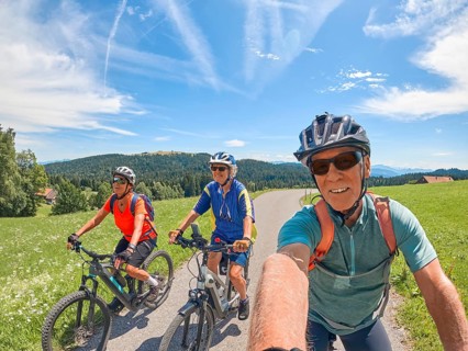 Group of active senior friends having fun during a cycling tour in the Allgau Alps near