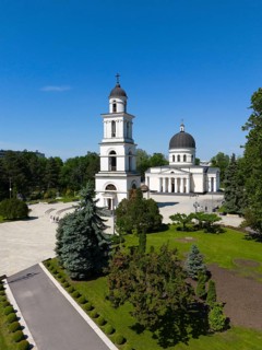 Cathedral with towers and dome surrounded by a well-kept park in clear skies, aerial view, Nativity