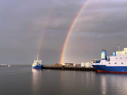 Two rainbows over a quiet harbor with several ships and cloudy sky, Kalmar, Kalmar Län, Sweden