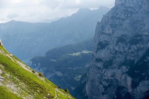 Hiker on a steep hiking trail, Bernese Alps, Bernese Oberland, Switzerland
