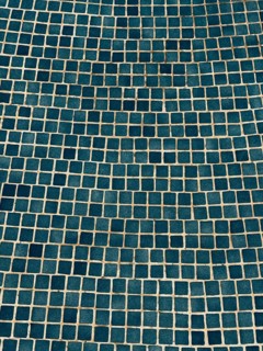 A visually captivating abstract image of a blue tiled wall, featuring a geometric mosaic pattern.