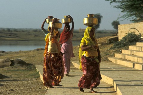 Women carry stuffed water balls on their heads at Gadsisar Lake, Jaisalmer, Rajastan, India