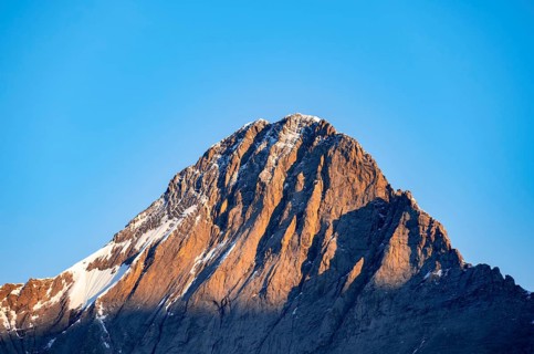 Impressive high-alpine landscape, Eiger mountain peak with alpine glow at sunrise, Bernese Alps,