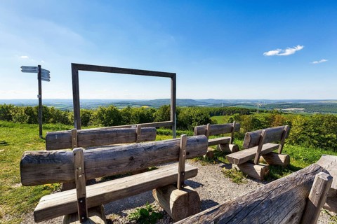 Wooden rest benches on mountain peaks, open-air cinema, panoramic view of the Weser Hills,