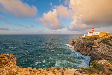View of the Lighthouse of Cabo de Sao Vicente in Sagres, Algarve, Portugal, at sunrise with
