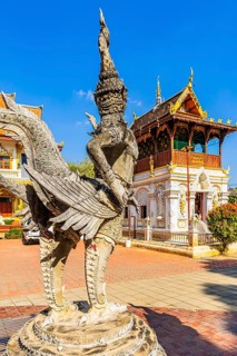 A human and bird-like stone creature in the Buddhist temple complex Wat Chiang Yuen, Chiang Mai,