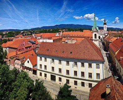 View of an old town with church, tiled roofs and a blue sky in the background, Zagreb, Croatia