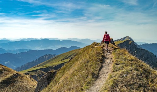 Nice senior woman, hiking in autumn on the ridge of the Nagelfluh chain near Oberstaufen, Allgaeu,