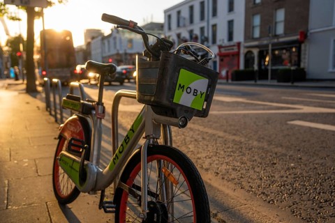 A rental bike is parked on the street at sunset, ready for use in the city, Dublin, Ireland