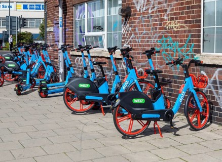 Public rental electric vehicles WEST e-bikes and e-scooters operated by micromobility company Dott,