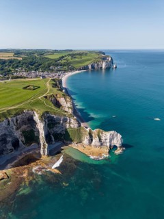 Aerial view of the Falaise d'Amont rock formation with the Porte d'Amont rock gate at low tide, on