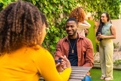 Diverse group of people participating in an outdoor group therapy session, engaging in