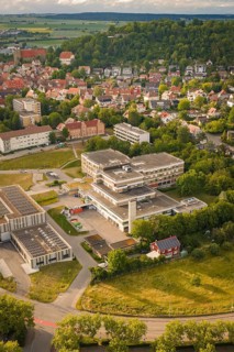 Urban environment with a large building in the foreground and residential buildings in the