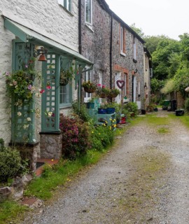 Industrial heritage housing, row of small historic textile wooden mill workers cottages,