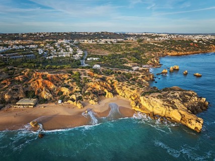 Aerial view of Praia de Sao Rafael beach with cliffs, turquoise water, beach, and Albufeira