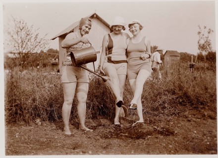 Allotment garden, swimwear, Three woman in swimwear gardening and laughing in natural surroundings,