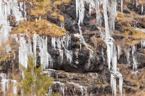 A steep rock face is covered with icicles on a very cold morning. Mühlviertel, Austria