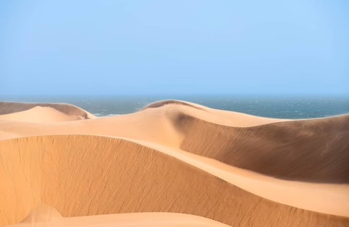 Sand dunes and sea, dune sea, impressive desert landscape, Sandwich Harbour, Namib Naukluft Park,