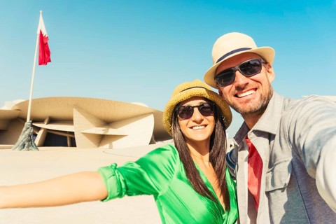 Doha, Qatar - 8th january, 2026: Happy young couple taking selfie in front of National museum of