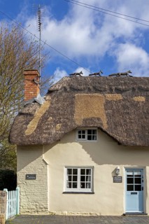 Animal wire figures on roof, thatched house, Bretforton, The Cotswolds, England, Great Britain