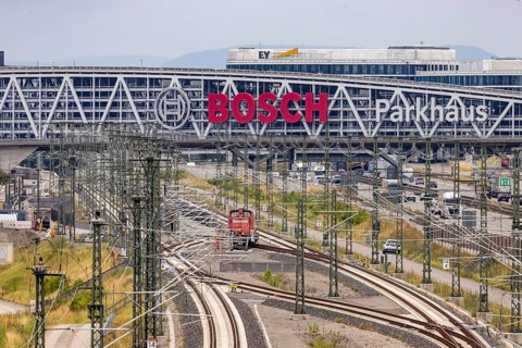 A8 motorway at Stuttgart airport with Bosch parking garage and new Deutsche Bahn AG line with