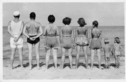 Kühlungsborn, Baltic Sea, A group of people standing on the beach wearing swimwear with their backs