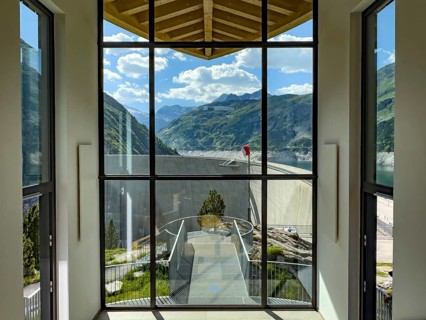 View through panoramic window in stairwell connecting parking lot to dam at Kölnbreinsperrre dam,