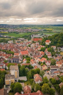 Historic town with many old buildings and a church, under a cloudy sky, Herrenberg, Böblingen