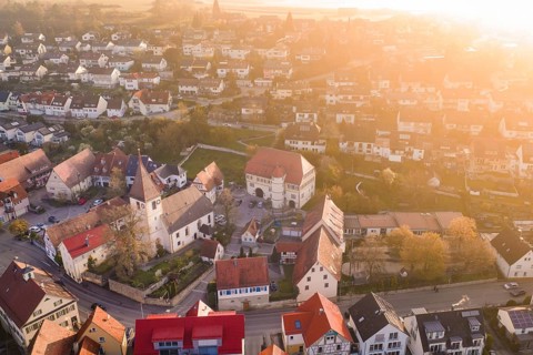 Village in evening light with colorful roofs and autumn colors from the air, Deufringen, Aidlingen,