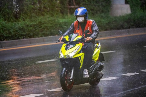 Motorcycle scooter in rain, Bangkok, Thailand