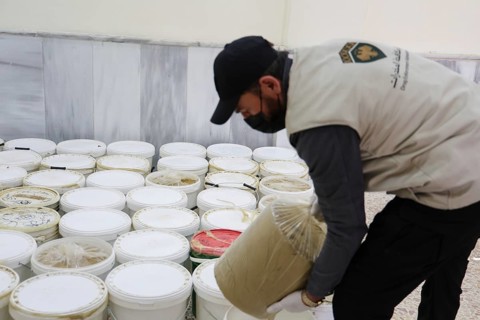 Personnel from the Syrian Anti-Narcotics Directorate display a massive cache of confiscated illegal