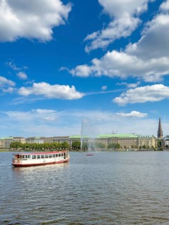 The Alsterdampfer Eilbek (fully electric) on the Inner Alster Lake, with the Alster Fountain,