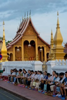 Morning alms, begging, thakbat of monks and novices of the monastery complexes in Luang Prabang,