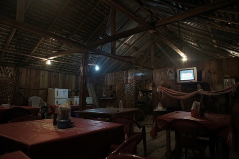 Rustic restaurant with wooden furniture and cozy lighting, San Lorenzo, Ecuador