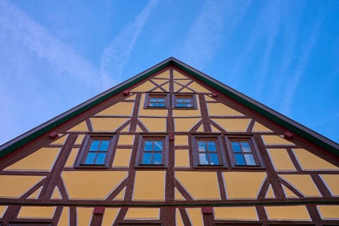 Traditional half-timbered house under clear blue sky, Lohr am Main, Schneewittchenstadt,