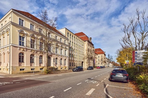 Buildings, historic residential buildings, bike path, road, vehicles, lawn, trees, blue sky,