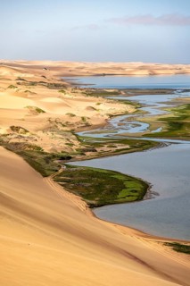 Sand dunes and sea, Sandwich Harbour Atlantic coast and lagoon, Namib Naukluft Park, Namib Desert,