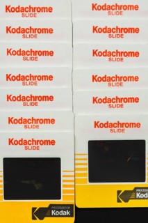 Close-up of two rows of neatly arranged old 1980s 35mm Kodak Kodachrome slides mounted in yellow