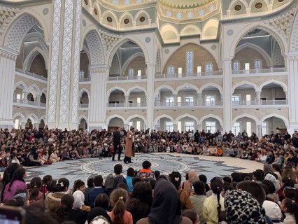 Dozens of Muslim children participate in indoor entertainment event inside a grand mosque during