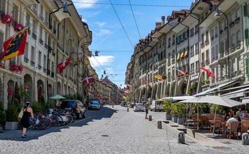 Gerechtigkeitsgasse with historic houses decorated with Swiss flags, old town, Bern, Canton of