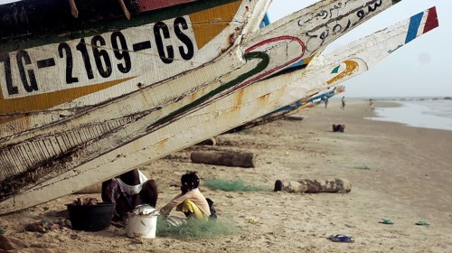 Fishing boats with people working on a sunny day, Cap Skirring, Casamance, Senegal