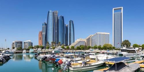 Abu Dhabi Skyline Etihad Towers skyscrapers with marina yacht harbor panorama in Abu Dhabi, United