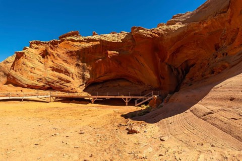 Biidi arch cave in page, arizona, displaying a striking sand colored canyon landscape, with a