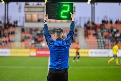 Sideline referee shows 2 minutes added time during the football match in Lubin, Poland