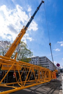 Mobi Hub, heavy construction machine with special technology setting up a crane in the narrow