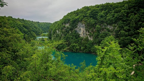 View of a quiet lake surrounded by wooded hills, Plitvice Lakes National Park, Croatia