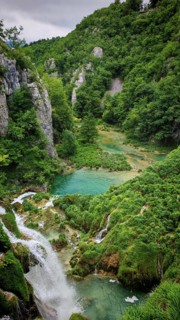 A small valley with a clear lake and surrounding vegetation, Plitvice Lakes National Park, Croatia