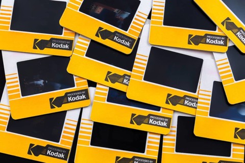Close-up of old loosely arranged 1980s 35mm Kodak Kodachrome slides mounted in yellow and white
